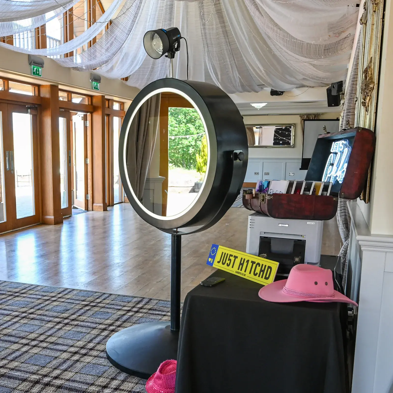 Illuminated circular Beauty Mirror booth set up at a wedding venue